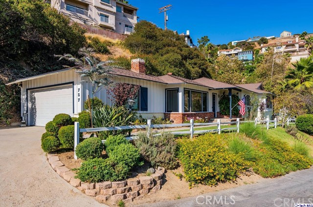 a view of a house with a yard patio and sitting area