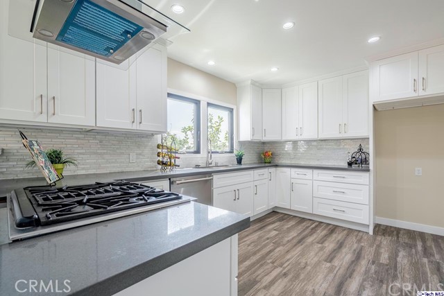 757 Cavanagh Road Glendale, CA 91207 - Photo 6 of 21 a kitchen with wooden floor stove and white cabinets
