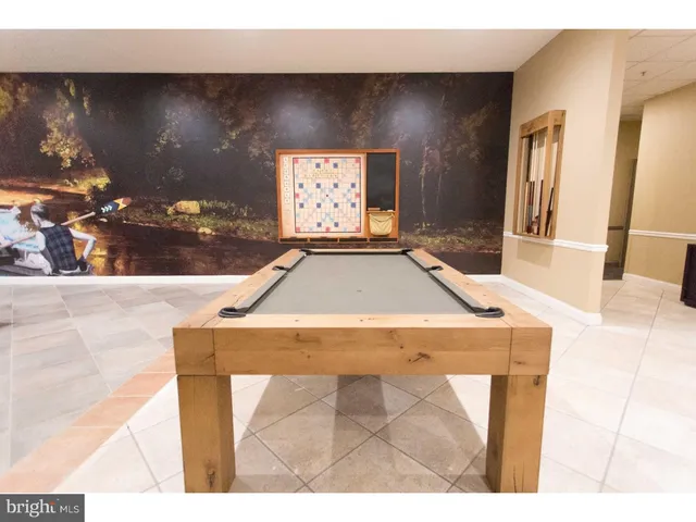 a room with pool table and chairs