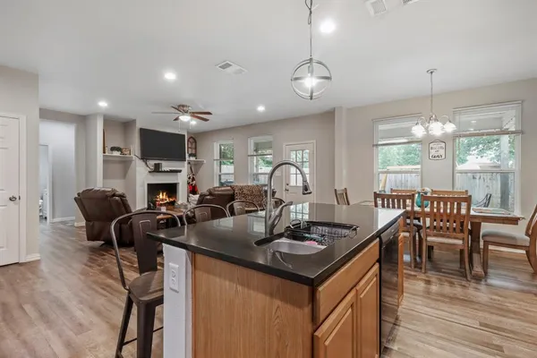 a view of a dining room with furniture a chandelier and wooden floor