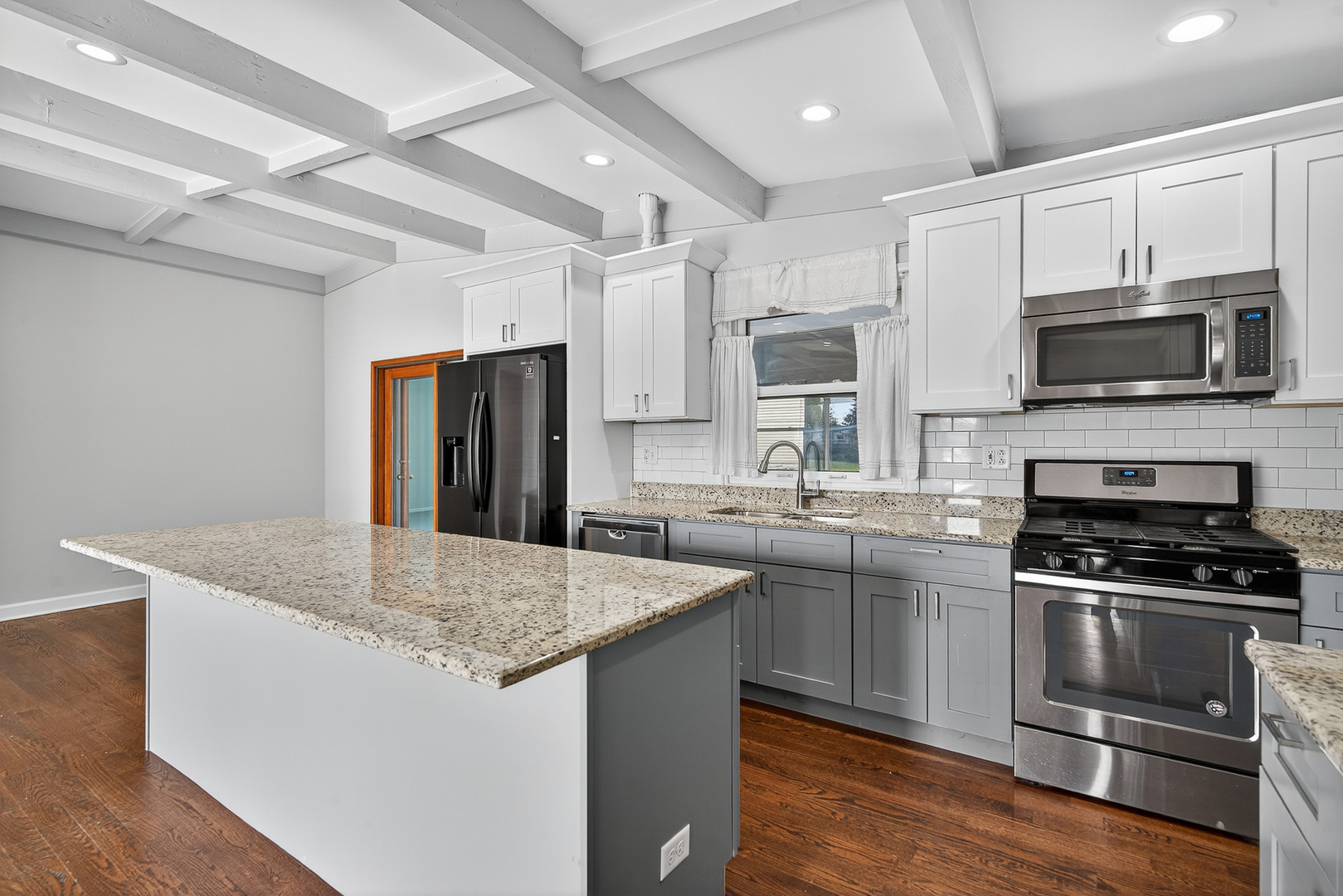 7818 West Argyle Street Norridge, IL 60706 - Photo 6 of 24 a kitchen with stainless steel appliances granite countertop a sink stove microwave and refrigerator