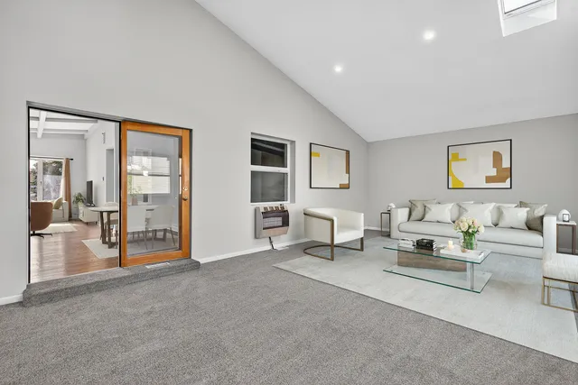 a living room with furniture and a table