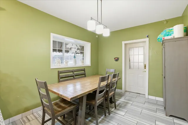 a view of a dining room with furniture and a chandelier