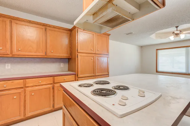 a white stove top oven sitting inside of a kitchen