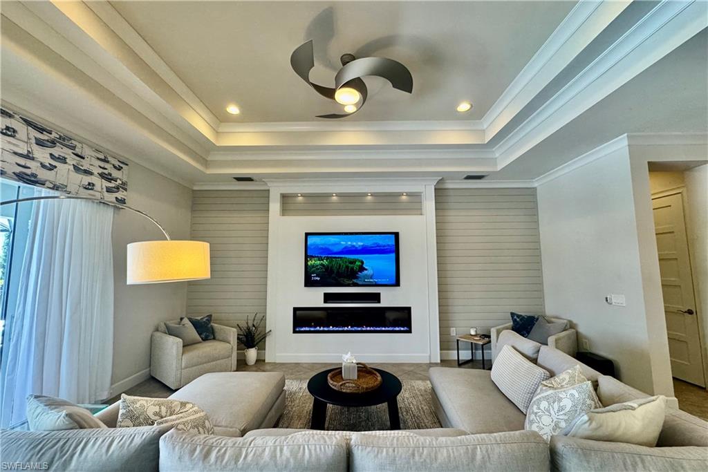 6466 Warwick Avenue Naples, FL 34113 - Photo 8 of 43 a living room with furniture and a flat screen tv