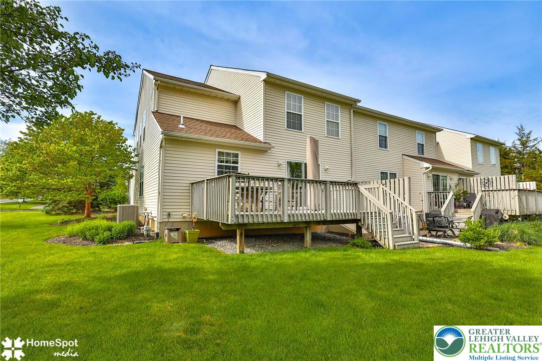 4191 Walter Road Bethlehem, PA 18020 - Photo 20 of 23 A spacious outdoor deck with stairs offers seamless access to the surrounding manicured green space.