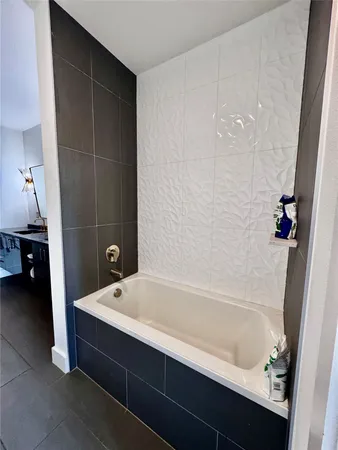 a bathroom with a bathtub and a sink