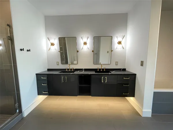 a bathroom with a granite countertop sink a vanity and a mirror