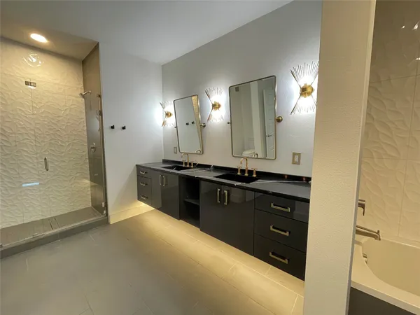 a bathroom with a double vanity sink a mirror and a shower