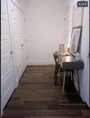 a view of a room with furniture and wooden floor