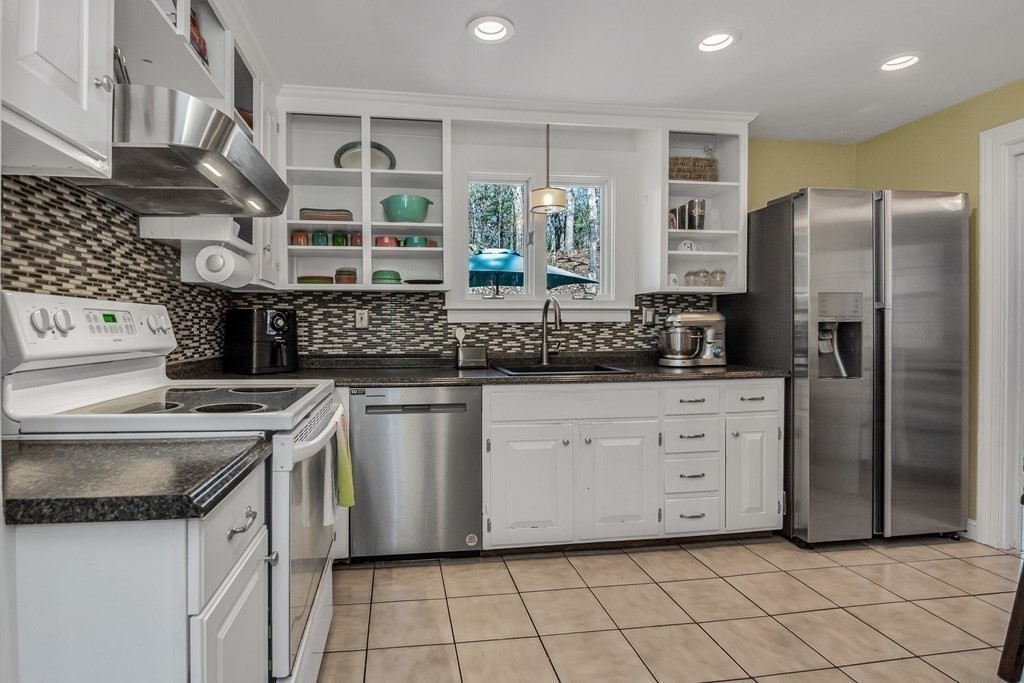 21 Stage Coach Road Boxford, MA 01921 - Photo 18 of 40 a kitchen with stainless steel appliances granite countertop a sink and a refrigerator
