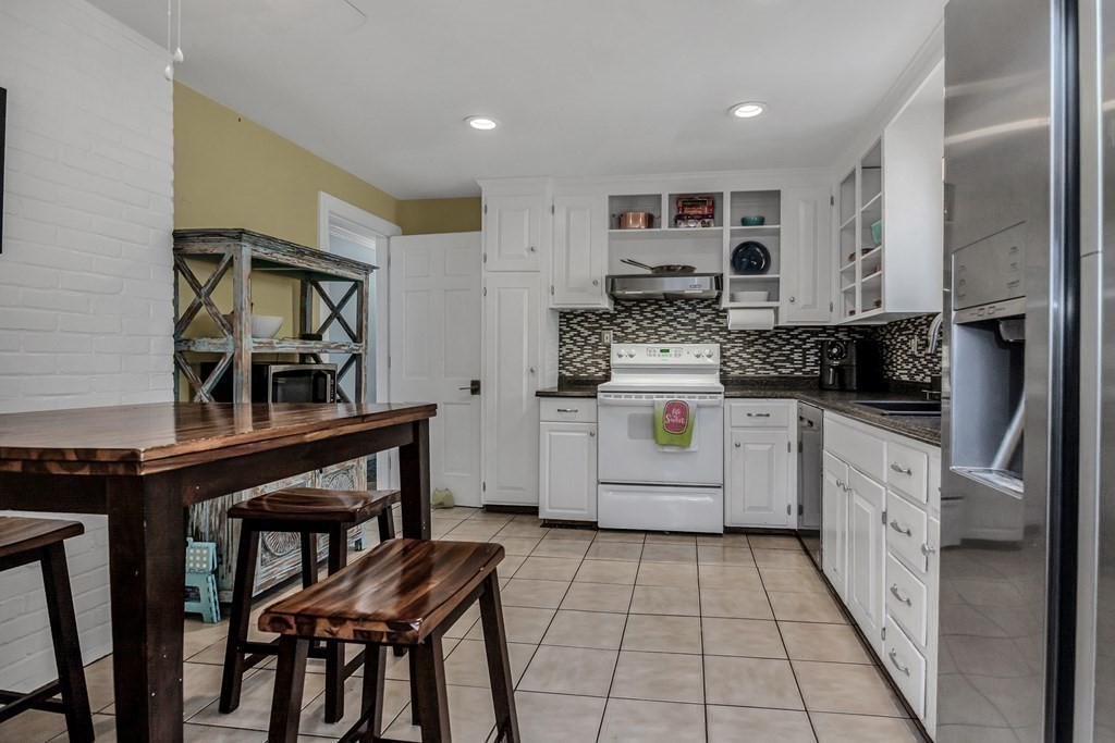 21 Stage Coach Road Boxford, MA 01921 - Photo 19 of 40 a kitchen with stainless steel appliances granite countertop a stove a sink and a refrigerator