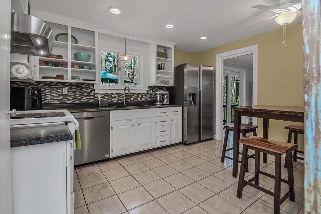 21 Stage Coach Road Boxford, MA 01921 - Photo 20 of 40 a kitchen with stainless steel appliances granite countertop a stove a sink and a refrigerator