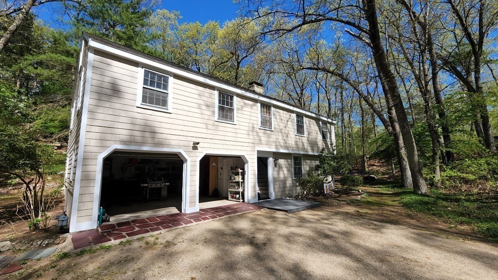 21 Stage Coach Road Boxford, MA 01921 - Photo 2 of 40 a front view of a house with a yard and garage