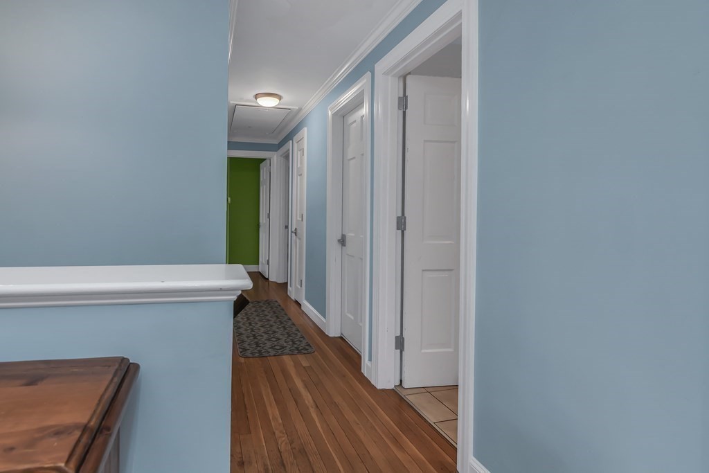 21 Stage Coach Road Boxford, MA 01921 - Photo 27 of 40 a view of a hallway with wooden floor and staircase