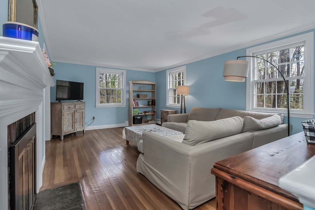 21 Stage Coach Road Boxford, MA 01921 - Photo 8 of 40 a living room with furniture flat screen tv and a fireplace