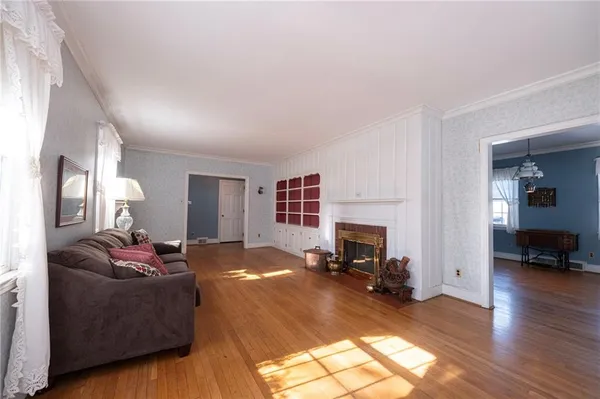 a living room with furniture window and a fireplace