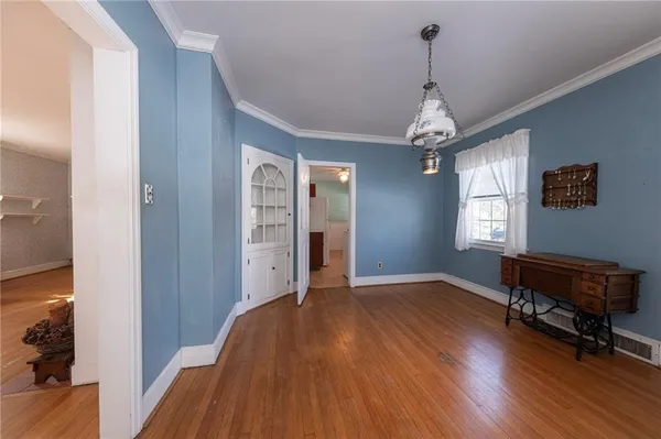 a view of a livingroom with wooden floor and a window