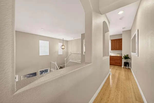 a spacious bathroom with a double vanity sink a mirror and a toilet