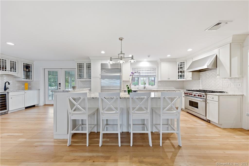 10 Plymouth Road Darien, CT 06820 - Photo 6 of 13 a kitchen with stainless steel appliances a table and chairs in it