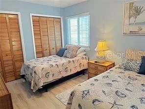 a bedroom with two beds and a window