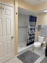 a bathroom with a toilet and shower