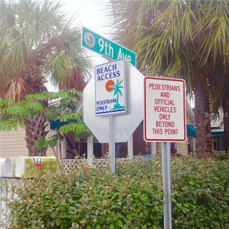 a sign broad in front of flowers