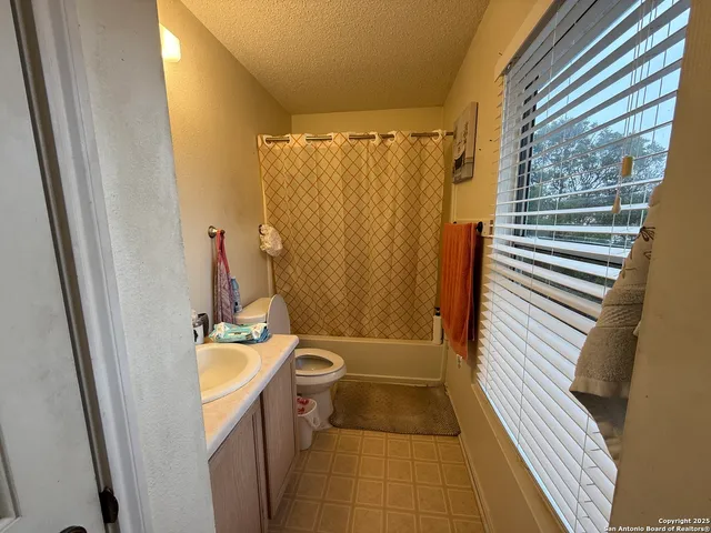 a bathroom with a sink a bathtub and shower