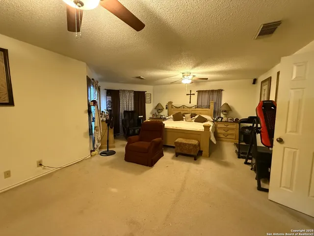 a bed room with furniture and a flat screen tv