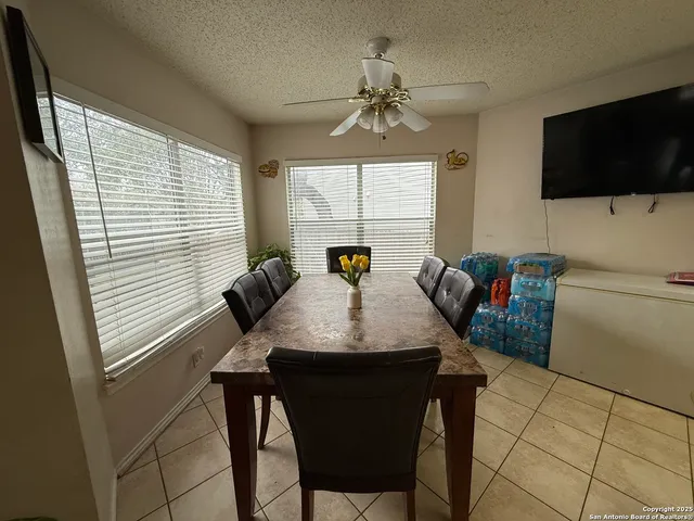 a view of a dining room with furniture and a flat screen tv