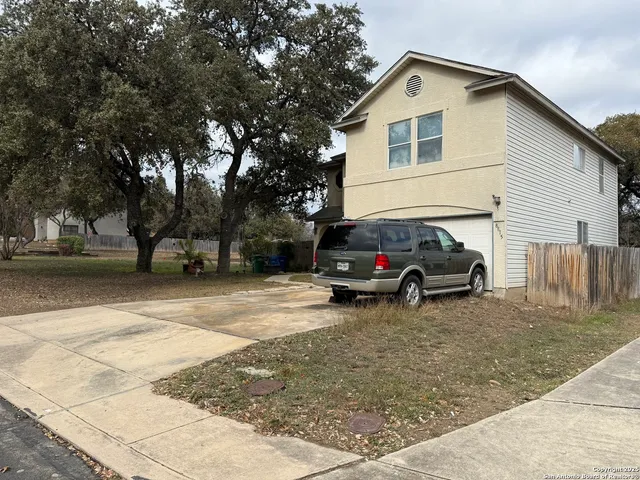 a view of a house with a cars parking space