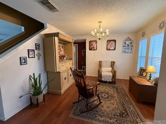 a living room with furniture and a chandelier