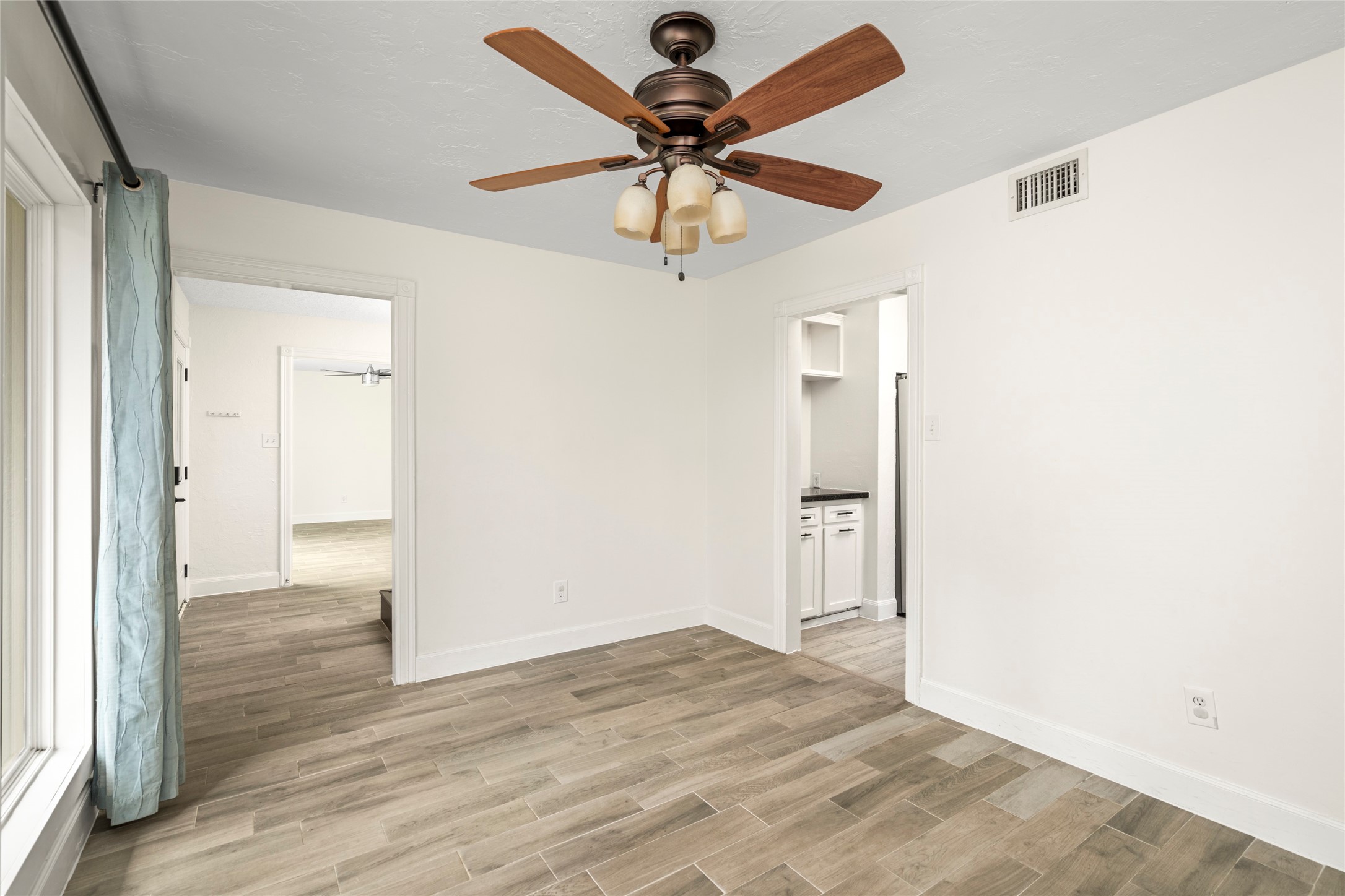 560 Landfall Lane Conroe, TX 77302 - Photo 26 of 41 Secondary view of the formal dining room into the foyer and kitchen.