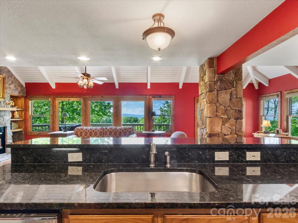 121 Ivy Ridge Road Burnsville, NC 28714 - Photo 14 of 48 a kitchen with stainless steel appliances granite countertop a sink window and cabinets