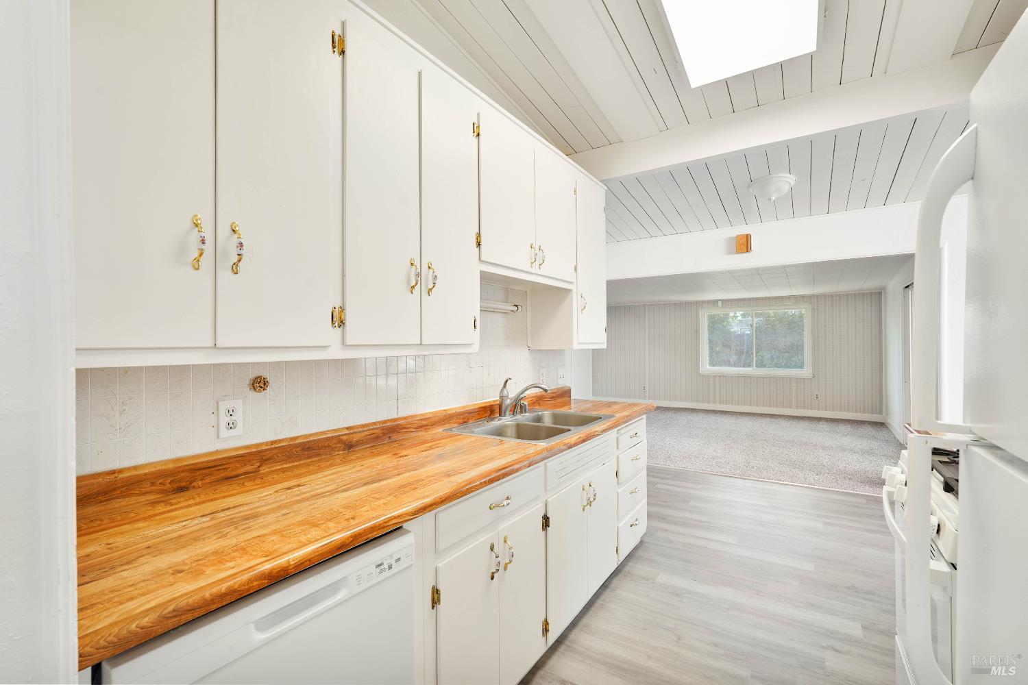 240 South 7th Street Dixon, CA 95620 - Photo 12 of 61 a kitchen with granite countertop white cabinets and white appliances