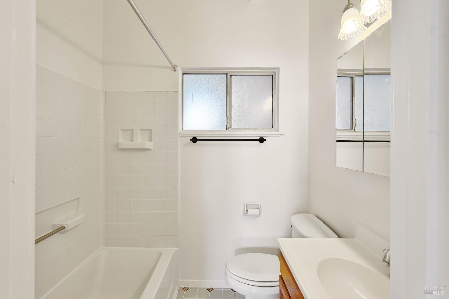 240 South 7th Street Dixon, CA 95620 - Photo 35 of 61 a white toilet sitting next to a bath tub