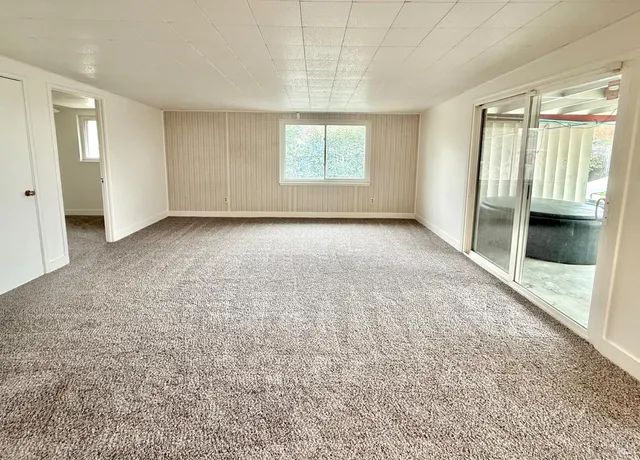 an empty room with windows and closet