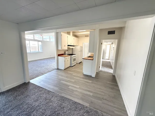 a kitchen with wooden floor and a stove top oven