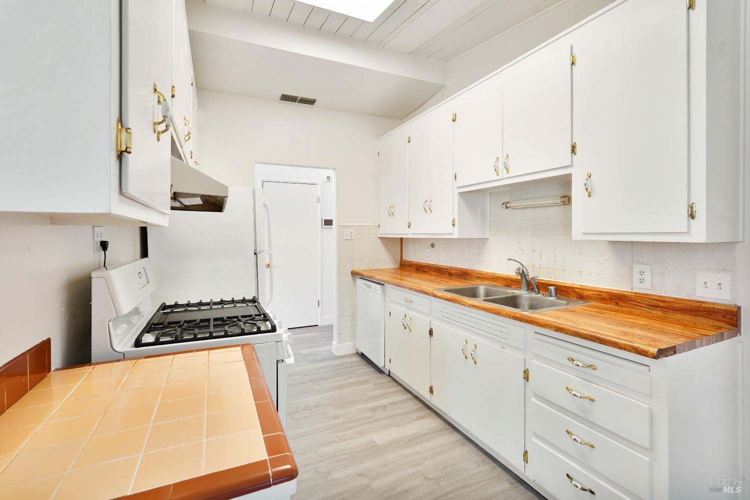 240 South 7th Street Dixon, CA 95620 - Photo 10 of 61 a kitchen with granite countertop a sink a stove and cabinets