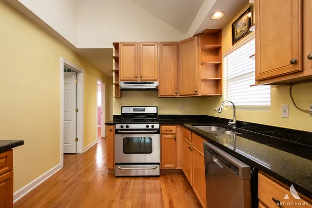 a kitchen with a sink a stove and cabinets