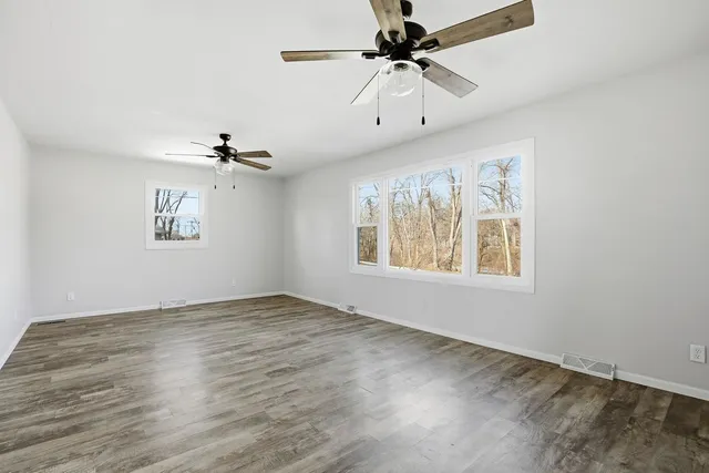 wooden floor in an empty room with a window