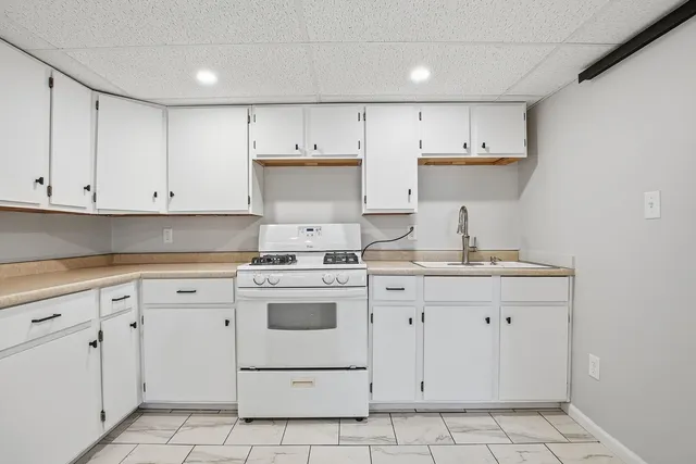 a kitchen with cabinets appliances and a sink
