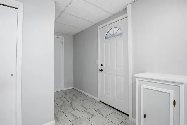 a view of a house with a yard and sitting area