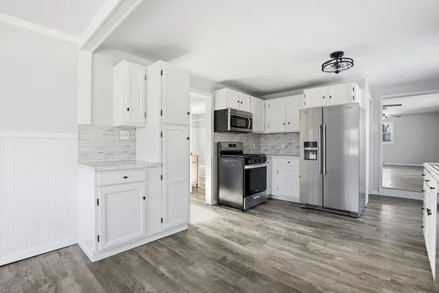 a kitchen with stainless steel appliances a refrigerator stove microwave and cabinets