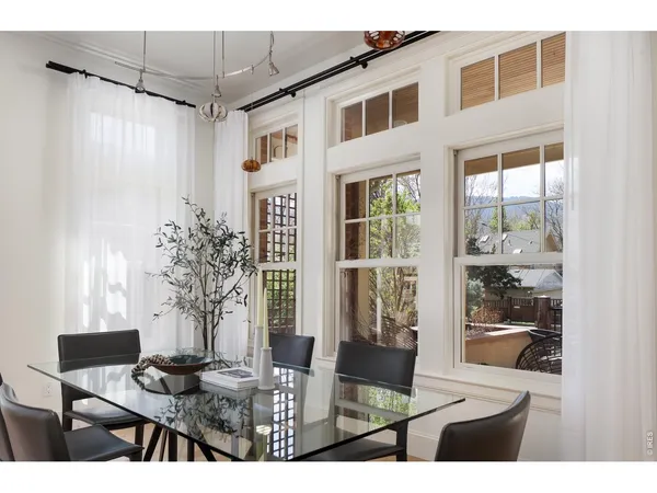 a kitchen with a table chairs sink and cabinets