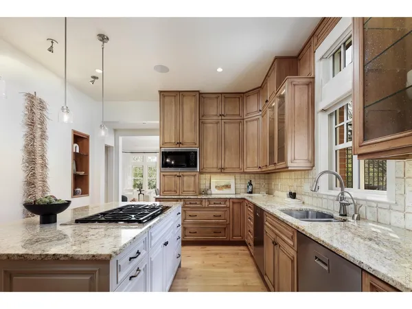 a kitchen with a sink appliances and cabinets