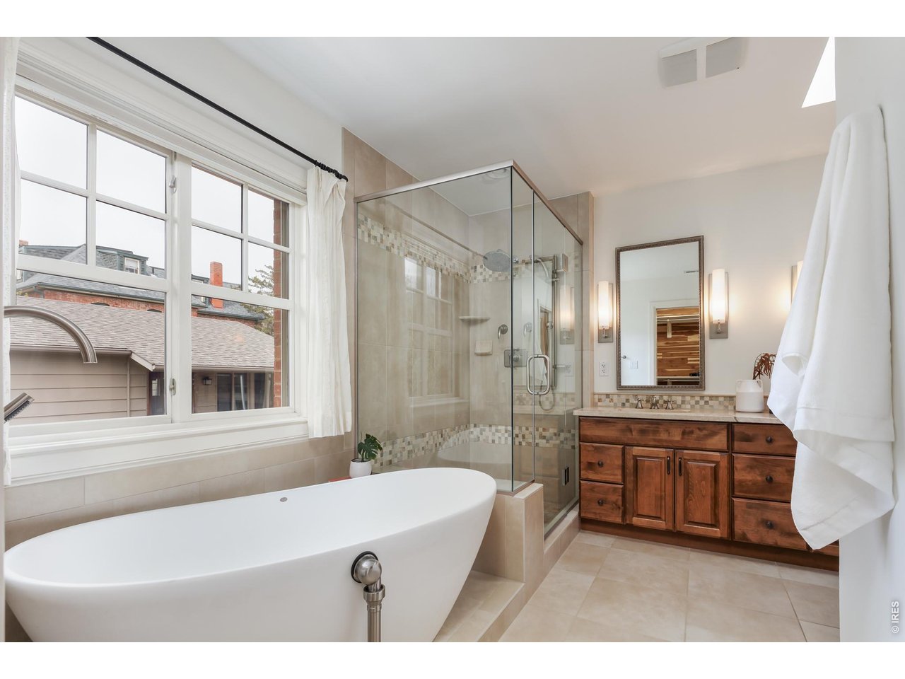 2125 11th Street Boulder, CO 80302 - Photo 25 of 48 a bathroom with a tub a sink and a large mirror