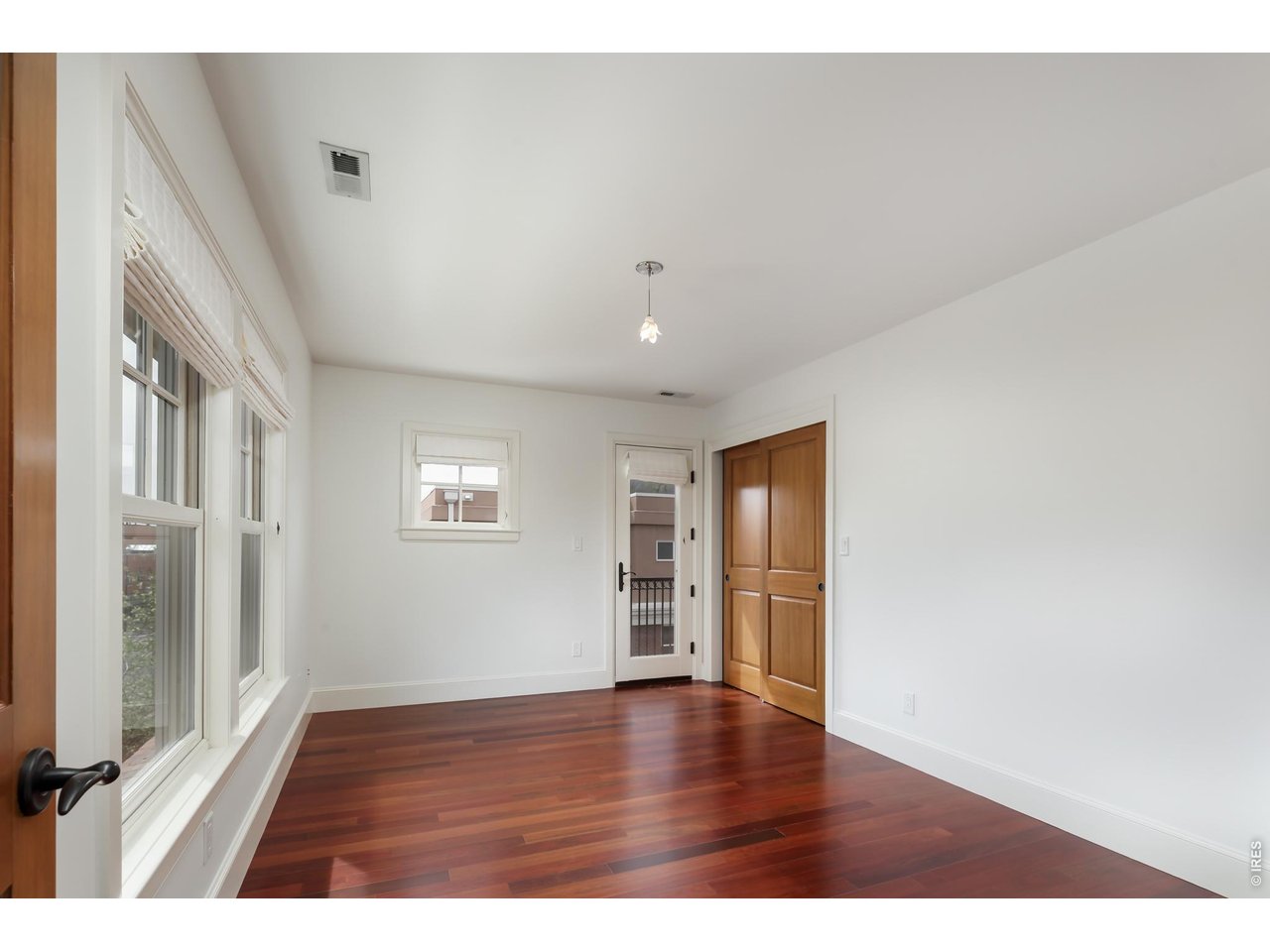 2125 11th Street Boulder, CO 80302 - Photo 28 of 48 a view of an empty room with a window and wooden floor