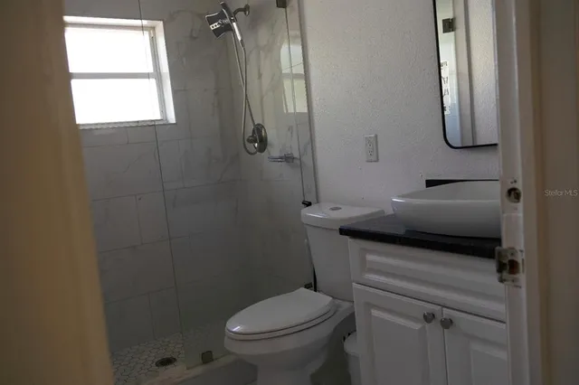 a bathroom with a mirror and a shower