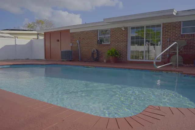 a view of a backyard with a table and chair